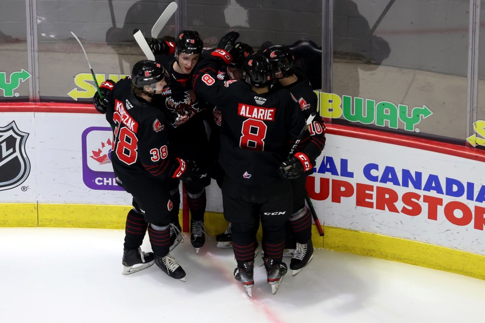 The Moose Jaw Warriors celebrate one of their four goals in regulation. 