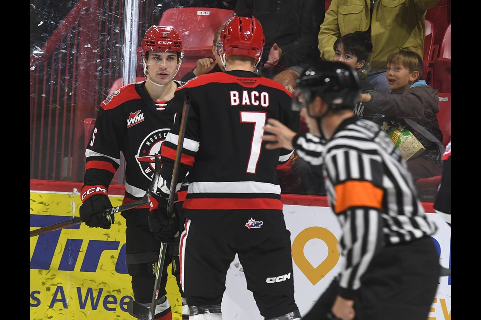 Warriors captain Denton Mateychuk and Robert Baco celebrate after the Warriors’ third goal.