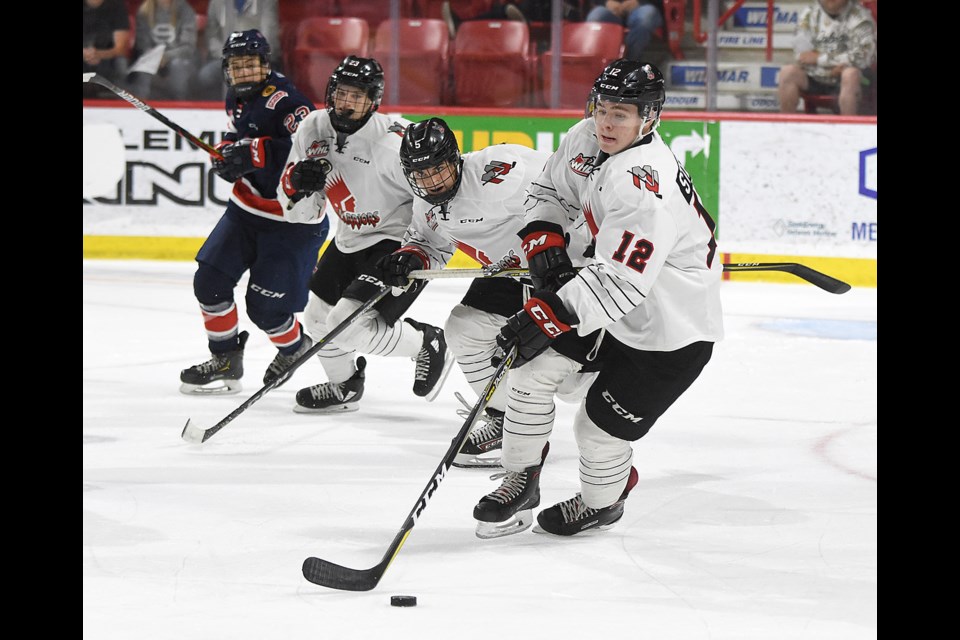 Cameron Sterling leads the rush as Denton Mateychuk (5) and Atley Calvert follow the play.