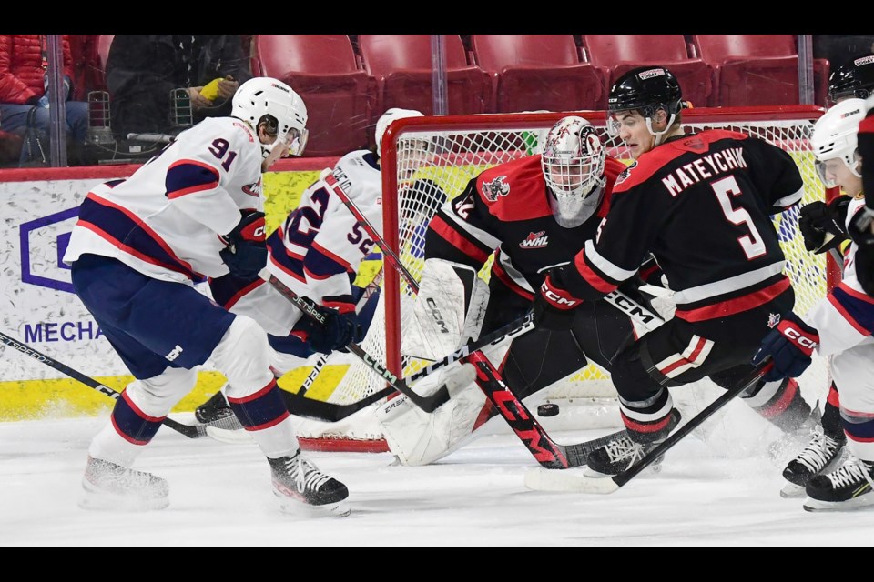 Connor Ungar keeps an eye on the puck as Denton Mateychuk covers the play.