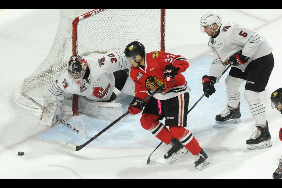 Warriors goaltender Brodan Salmond turns aside Portland's Haydn Delorme in close. Randy Palmer photograph