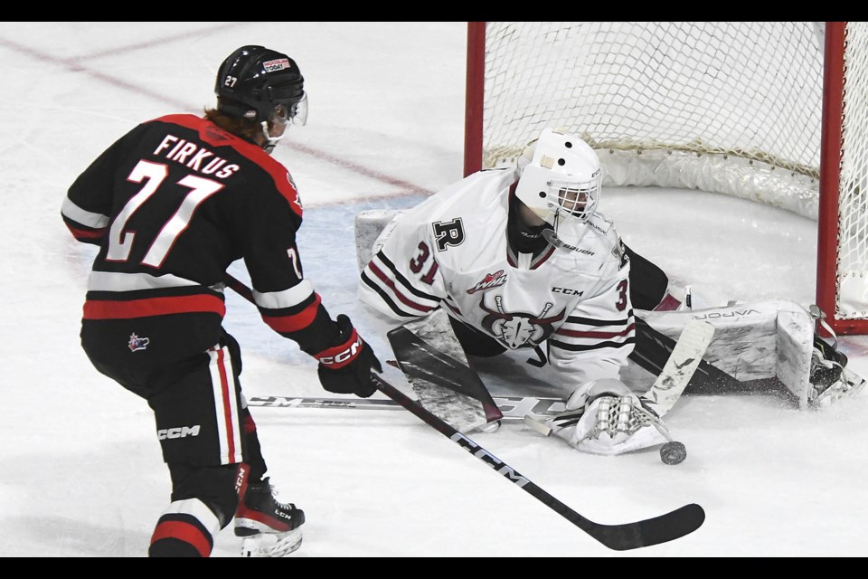 Red Deer goaltender Kyle Kelsey had to look behind himself after this Jagger Firkus shot.