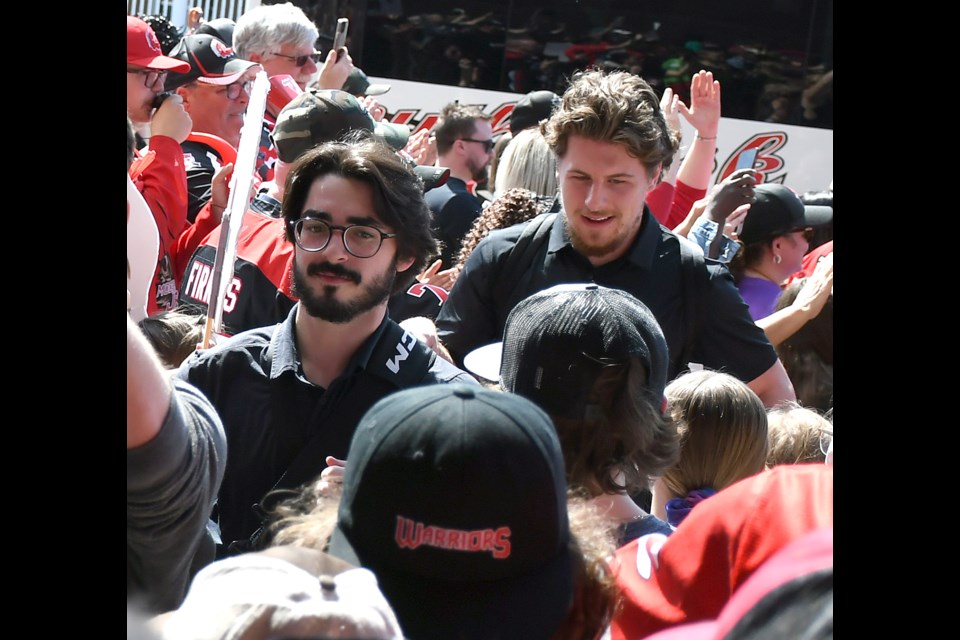 Moose Jaw Warriors Matthew Savoie and Martin Rysavy make their way through the crowd after arriving home from Portland on Sunday afternoon.