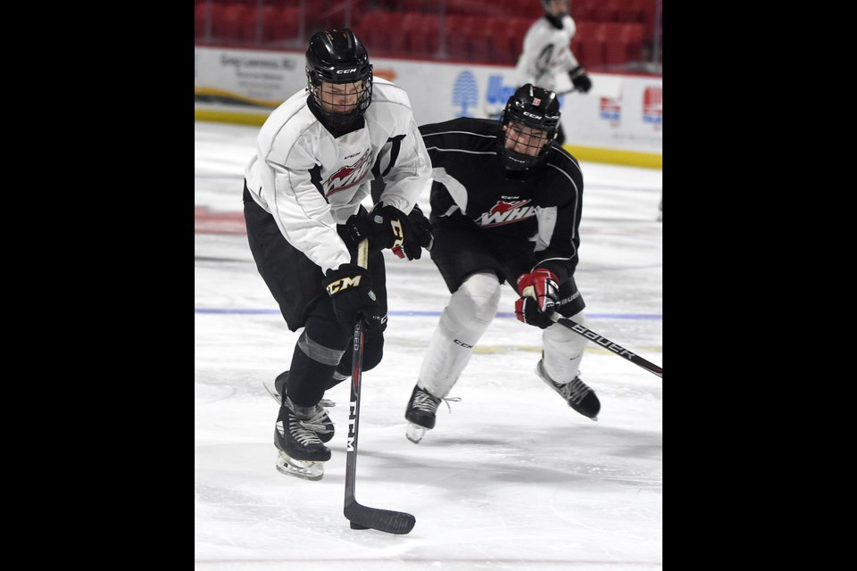Moose Jaw Minor Hockey products and Warriors hopefuls Kirk Mullen (white) and Carter Price do battle during the second rookie camp scrimmage on Friday afternoon.