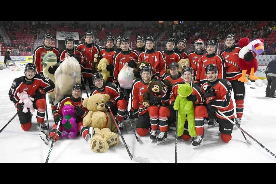 The Moose Jaw Warriors gather for the customary Teddy Bear Toss team photo.