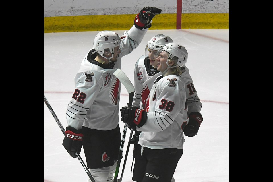 Warriors defenceman Carson Sass celebrates with Tate Popple and Ryder Korczak after Popple’s shorthanded game-winning marker.