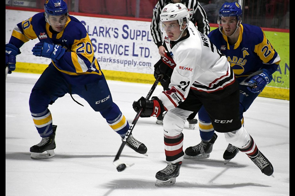 Garrett Wright clears the puck out of the Warriors zone as Saskatoon’s Alex Morozoff looks on.