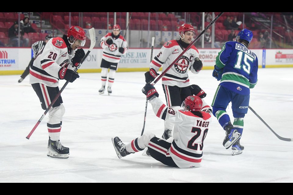 Warriors forward Brayden Yager celebrates his second goal with Pavel McKenzie (20) and Denton Mateychuk.