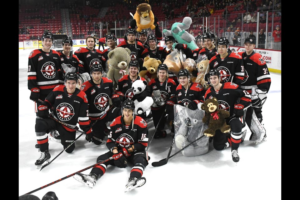 The Warriors gather for a team photo as as the teddy bears are gathered for the Salvation Army.