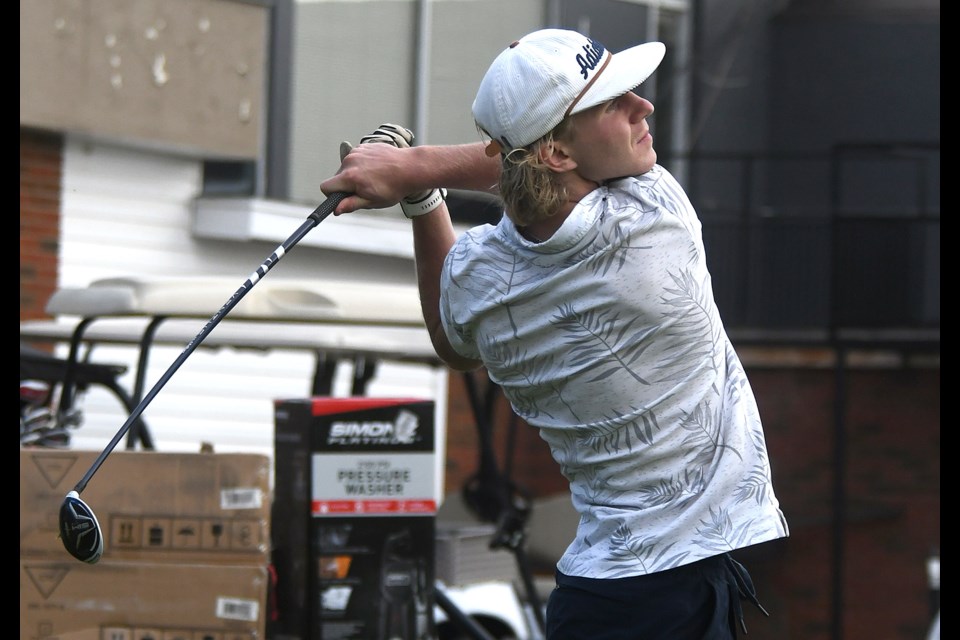 Former Warrior and current New York Rangers prospect Ryder Korczak tees off on the first hole.