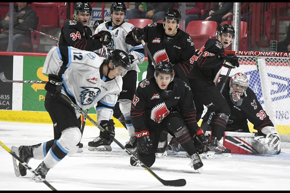 Warriors forward Cade Hayes (17) might have lost his stick, but that didn’t keep him from trying to stay in the play.