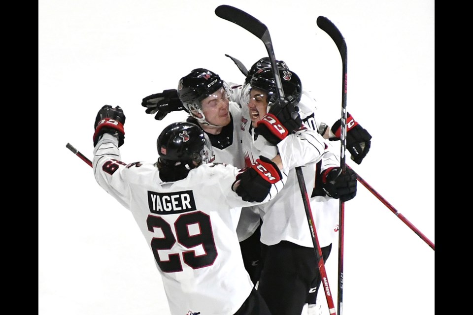 The Warriors celebrate after Denton Mateychuk’s game-winning goal on Saturday night.