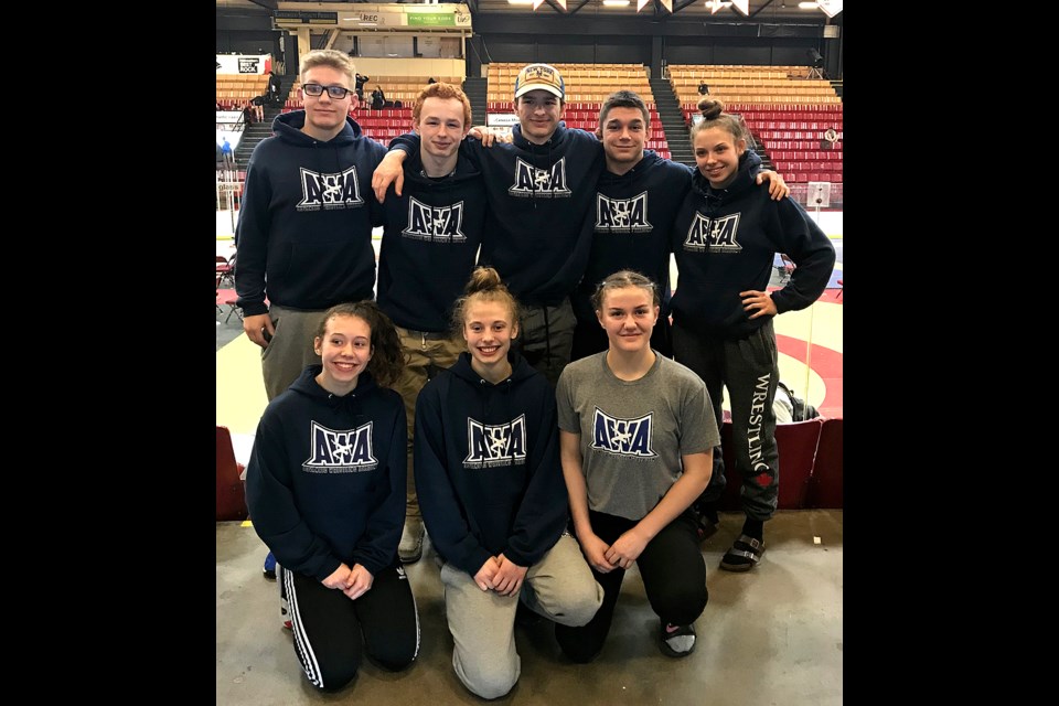 Kyle and Dylan Yamniuk pose with their Regina Advanced Wrestling Academy teammates at the Wrestling Canada national championships in Fredericton, N.B. Pictured are Alex Eisler (back left), Kyle Yamniuk, Dylan Yamniuk, Ben Bigelow, Jenna Petryna, Jada Baker (front left), Eve Neithercut and McKenna Ricard.