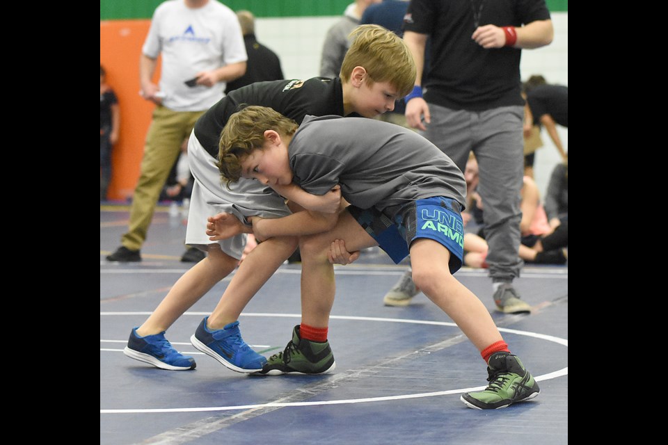 Vadin Oncescu of the Moose Jaw Kinsmen Wrestling Club shoots in for a single leg, leading to....