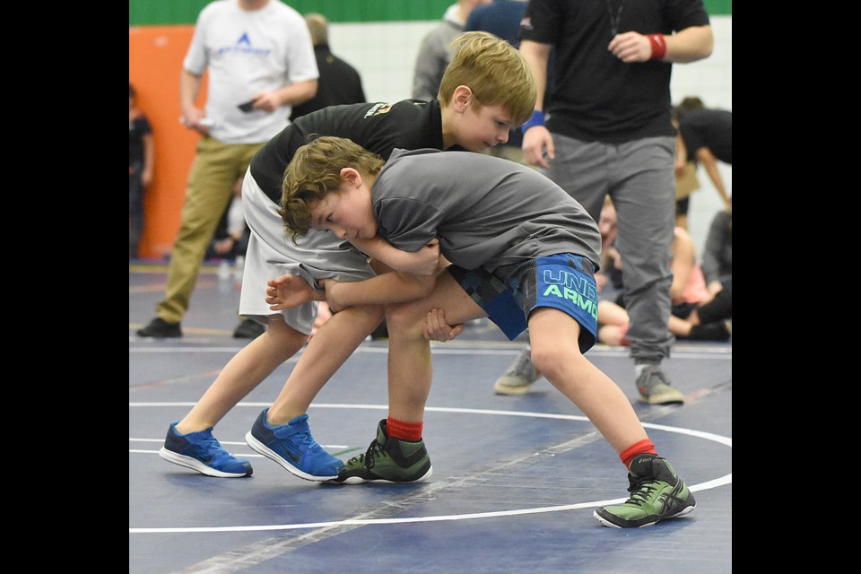 Vadin Oncescu of the Moose Jaw Kinsmen Wrestling Club shoots in for a single leg, leading to....