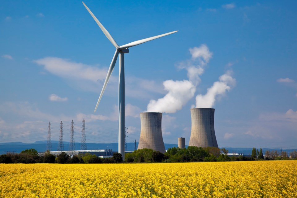 wind power and a nuclear stack (Sylvain Sonnet - The Image Bank - Getty Images)