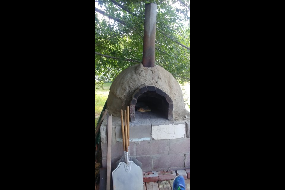 A wood-fired pizza oven made with clay from the area. Photo by Jason G. Antonio 