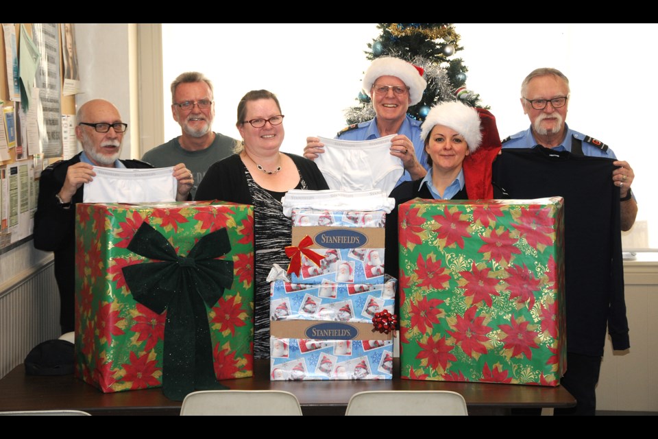 Sask. Polytechnic commissionaires Allan McLellan (back left), Bill Friars, Allan Vance, Jim Kleckners and Patricia McKibben (front right) are joined by Riverside Mission interim manager Rachel Mullens for a special donation of Stanfields underwear.