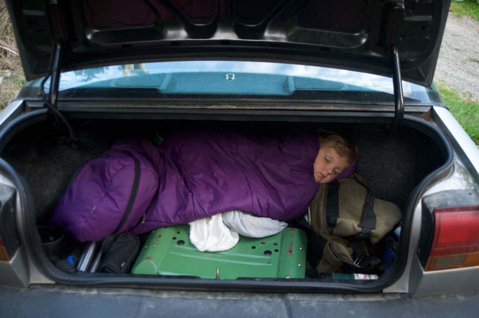 A homeless child sleeps in the trunk of a car as winter approaches (Aaron McCoy-The Image Bank-Getty Images)