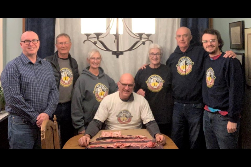 Jeff Woodward (seated, centre) poses with his family after making his weather predictions using pig spleens. Photo courtesy Facebook