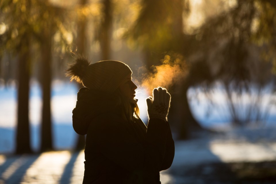 warming hands on cold morning shutterstock