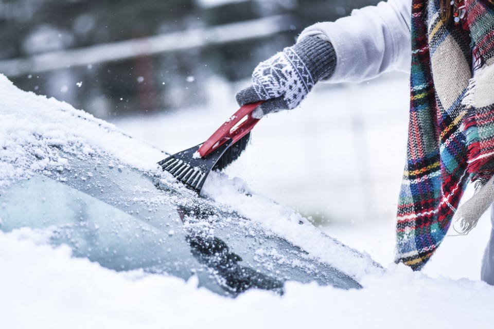 winter scraping windshield stock