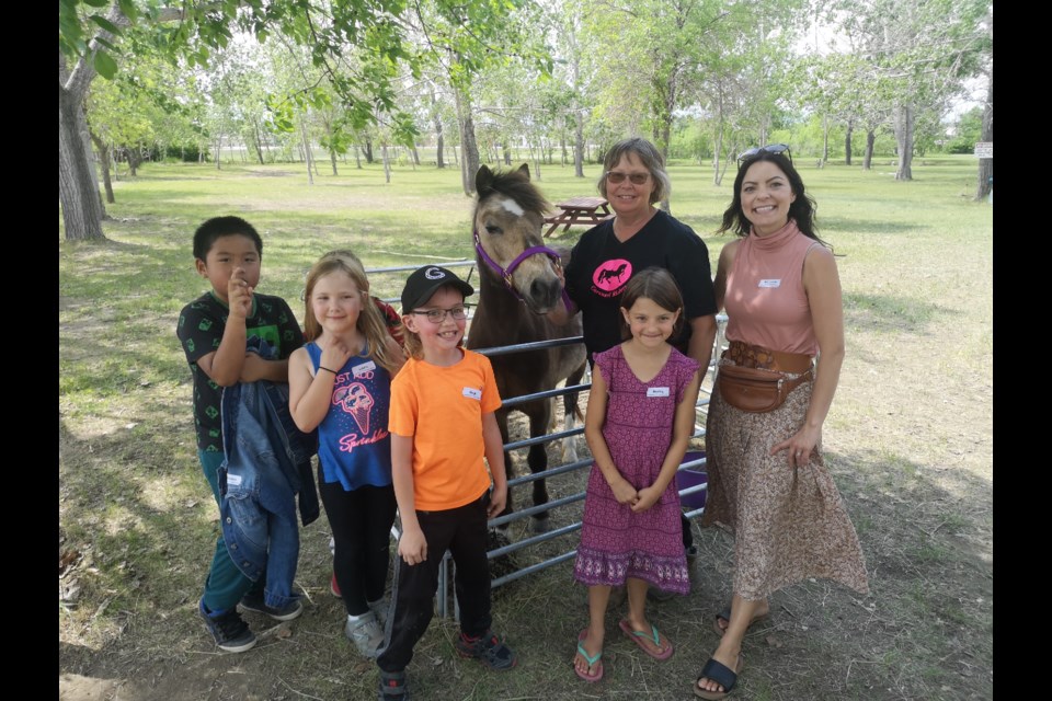 Grade 2 students from Assiniboia Seventh Avenue School visit Rollo the horse during the 2023 Museum Day at the Moose Jaw Western Development Museum