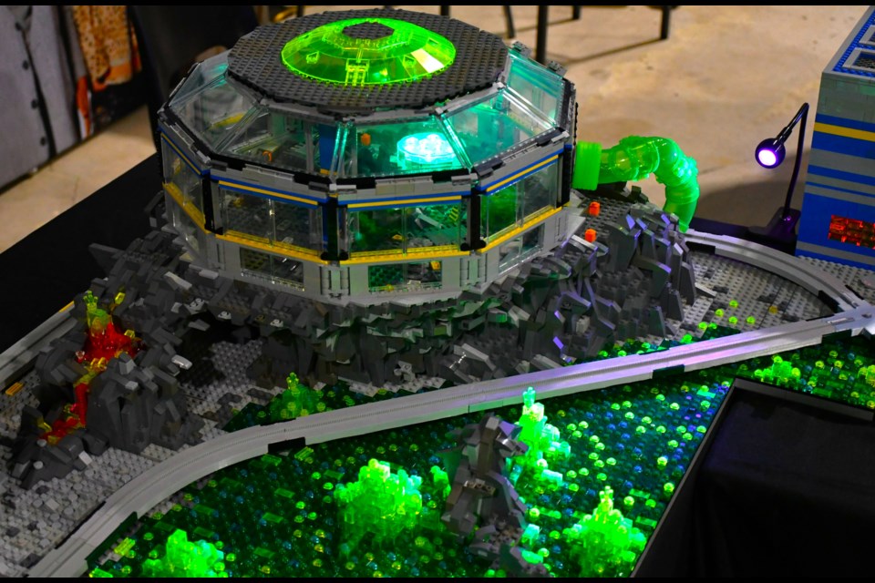 A look at Jeff Beaton’s sci-fi-themed build at Brickspo 2025, featuring a futuristic base and alien terrain brought to life with translucent bricks and black light effects.