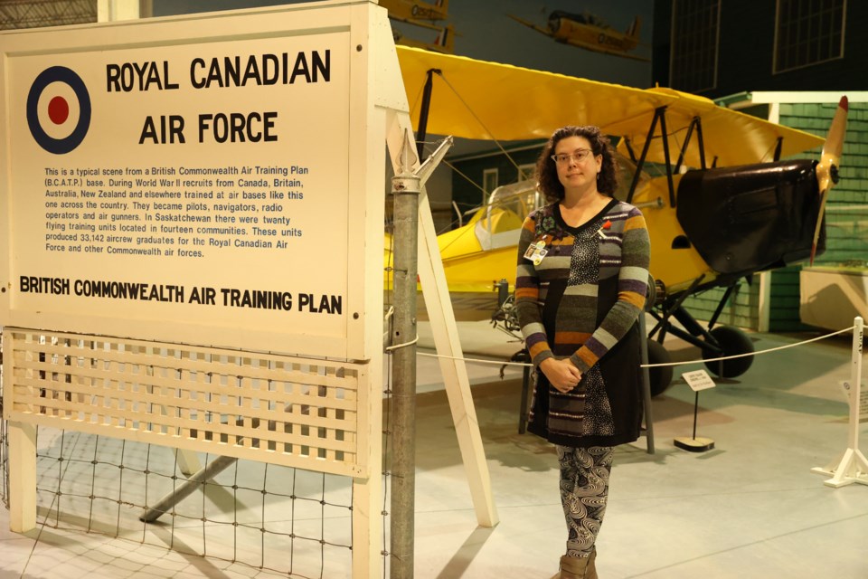 Karla Rasmussen in front of Royal Canadian Air Force British Commonwealth Air Training Plan aircraft at the WDM
