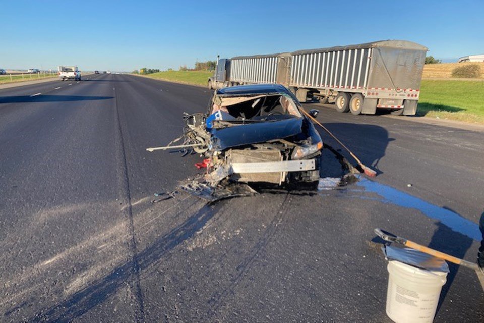 An early morning crash on Aug. 25 at the top of Antler Hill between a motor vehicle and semi truck resulted with injuries to the car driver and serious damage to his vehicle. 
Photo courtesy of the Innisfail Fire Department