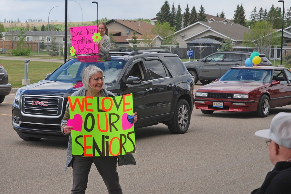 Lorey Marsden, in the foreground, Greenwood Neighbourhood Place Society's senior service provider, and Rayelle Johnson, the society's summer youth programmer, joined the parade procession on Wednesday, June 3 to spread cheer and smiles to Sundre's seniors. 
Simon Ducatel/MVP Staff