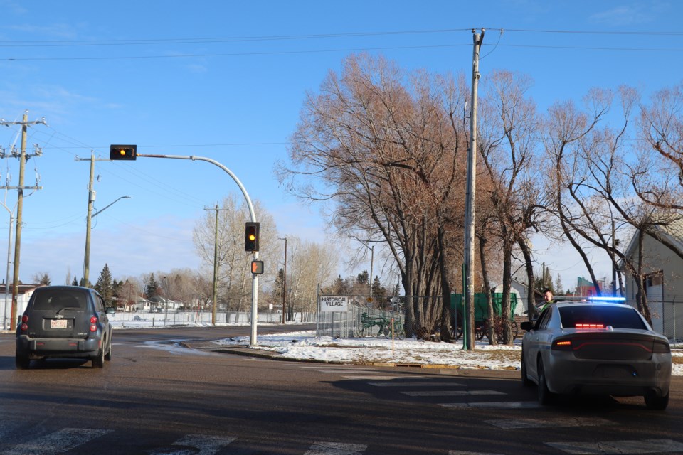 An Alberta Sheriffs Branch member blocks the southbound intersection of 52nd Avenue and 42nd  Street this afternoon during a police operation that resulted in the arrest of three suspects.