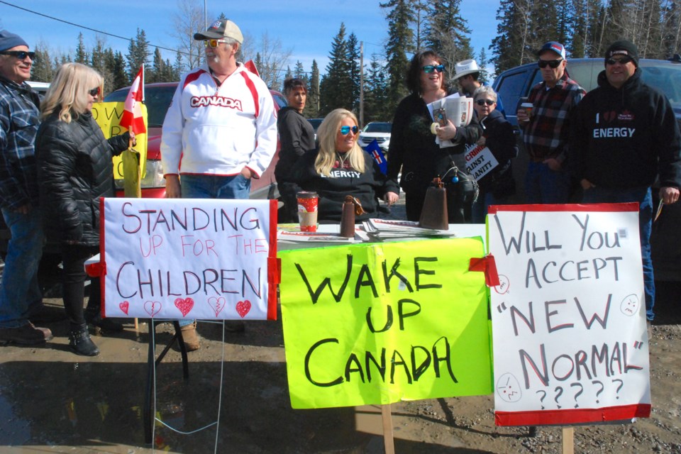 Sundre and area residents Norm Thiesen, third from the left, and Brenda Day, third from the right, were among roughly 150 people who attended the Mountain View Freedom group's anti-lockdown rally in Sundre on the afternoon of Saturday, March 27. Former Innisfail councillor Glen Carritt, at right, who is now running for mayor in that municipality, also attended and addressed the crowd. 
Simon Ducatel/MVP Staff