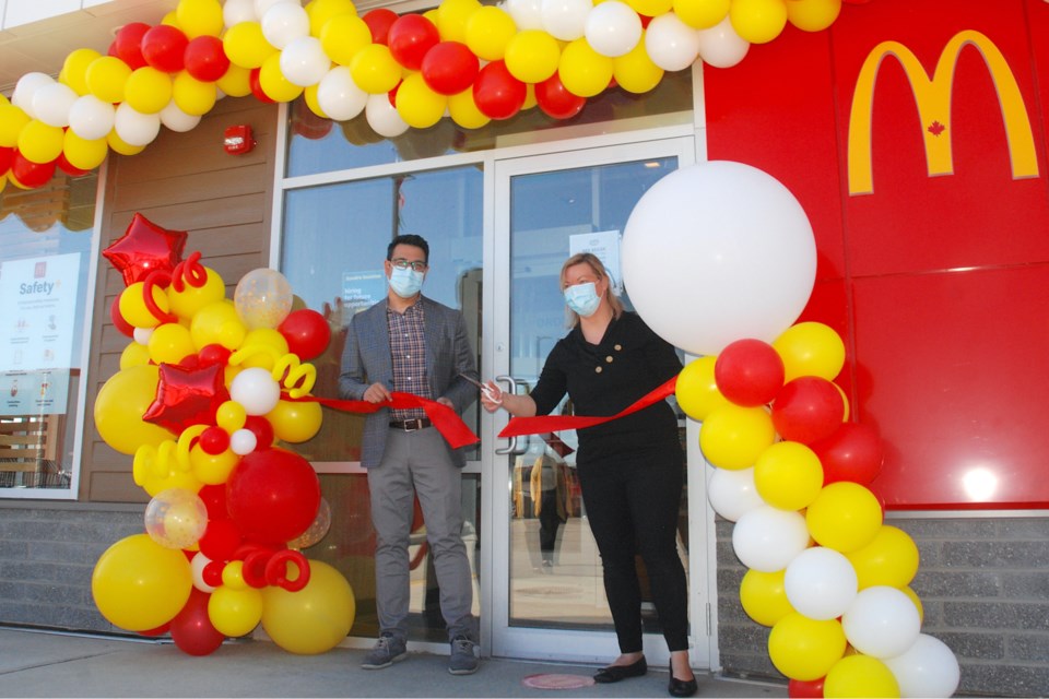 Usman Jutt, Sundre McDonald’s restaurant franchisee, and Nicole Davies, operations supervisor, cut the ribbon during a low key grand opening ceremony on Friday, May 14. 
Simon Ducatel/MVP Staff