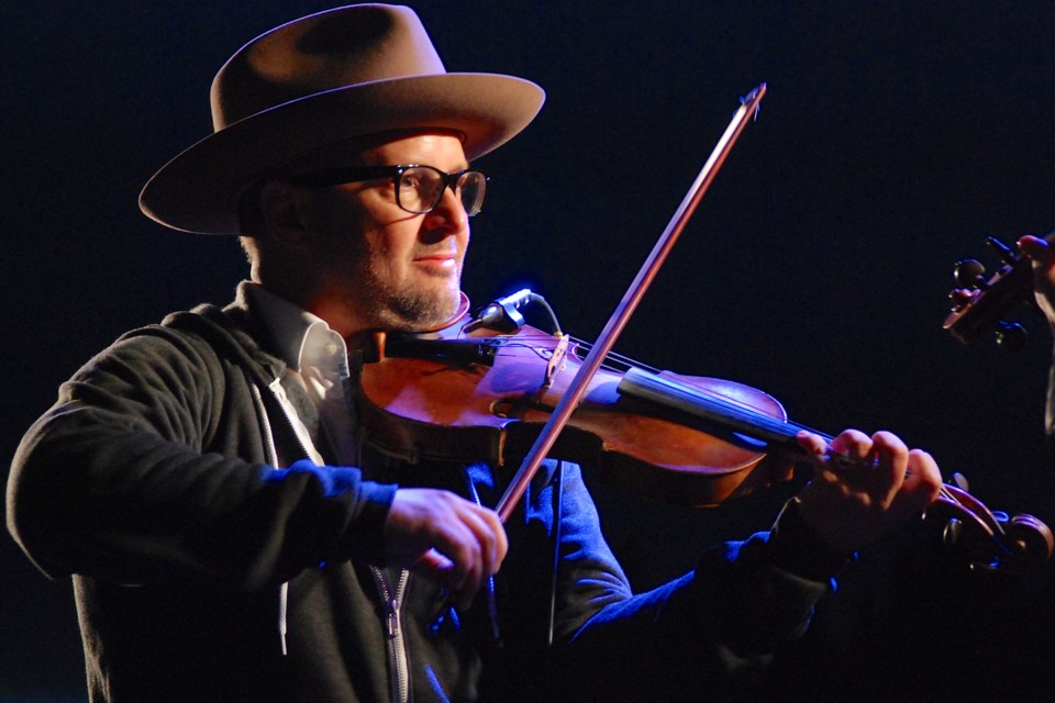 Accompanied on stage by wife Megan Ann Konschuh, Denis Dufresne performed on a variety of acoustic instruments including a fiddle and mandolin.  
Simon Ducatel/MVP Staff