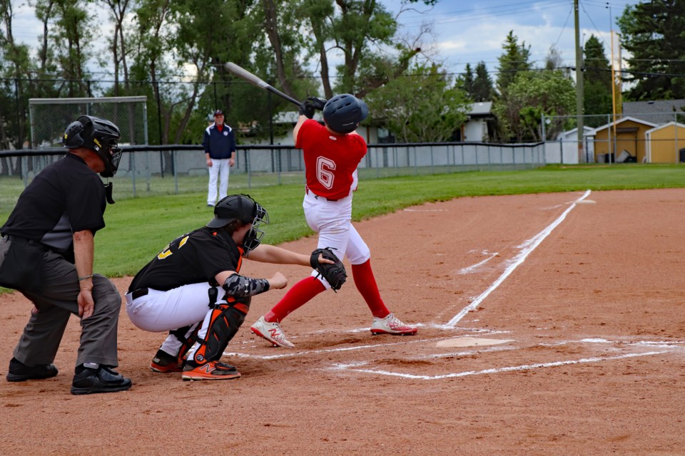 Zach Wilson of the U18 AA Innisfail Hawks takes a mighty swing at the plate during the wild season opening game against the Central Alberta Hounds on June 15 at the Innisfail Aquatic Centre baseball field. The Hounds won 17 to 15. Johnnie Bachusky/MVP Staff