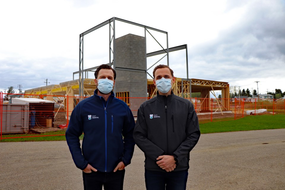 Dr. Isaac Day, left, and his brother Dr. Jacob Day in front of their new two-story home under construction beside the Henday Mall. The two dentists have served the town for the past decade. Johnnie Bachusky/MVP Staff