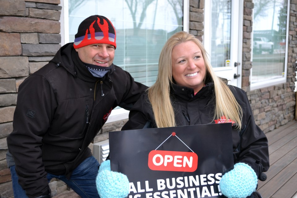 Glen Carritt with a supporter at the controversial barbershop rally in Innisfail on Jan. 12. Carritt's support of a local business to defy provincial COVID-19 restrictions and open their service to the public led to his resignation from council the previous day. Johnnie Bachusky/MVP Staff