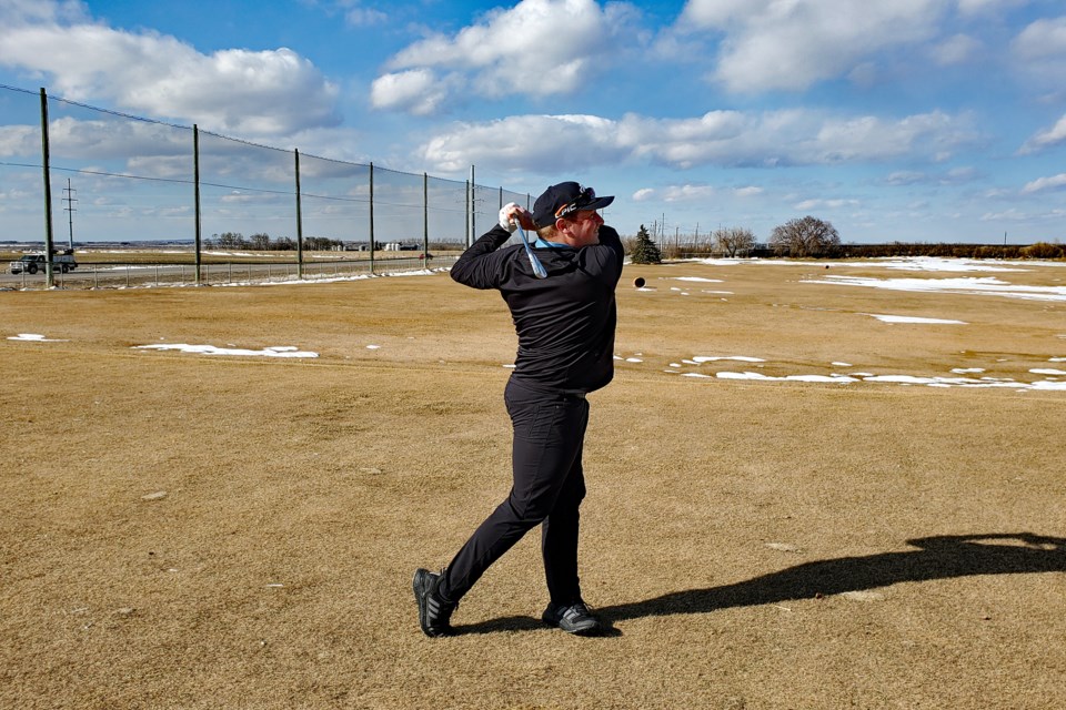 Mathew MacDonald, the new head professional at the Innisfail Golf Club, takes a mighty swing last week as the club gets ready for its April 16 opening for the 2021 season. 
Photo by Chris Herkel