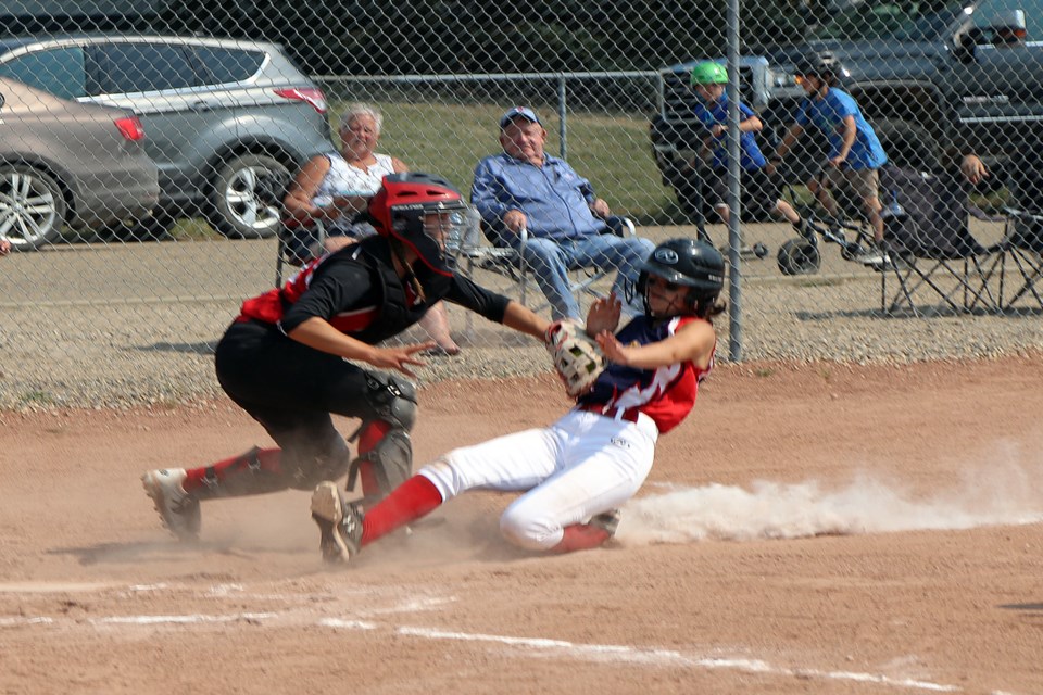 Catcher Seleah Organ of the Olds Pistols U16 squad puts the tag at home plate on Dylan Graham-Hunt of the Stettler Storm in first inning action during the July 17th game at the Innisfail Minor Softball Tournament.  Johnnie Bachusky/MVP Staff