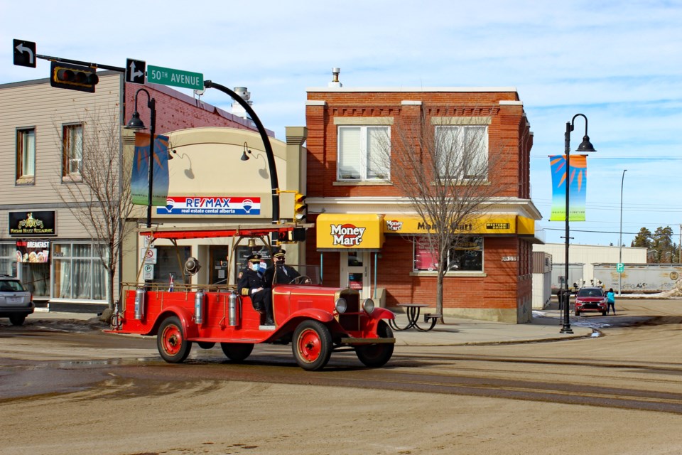 On March 1, Innisfail firefighter John Syroid was taken for a ride along Main Street in a vintage 1929 Chev fire truck in honour of his 45 years of service to the Innisfail Fire Department. Photo courtesy of the Town of Innisfail