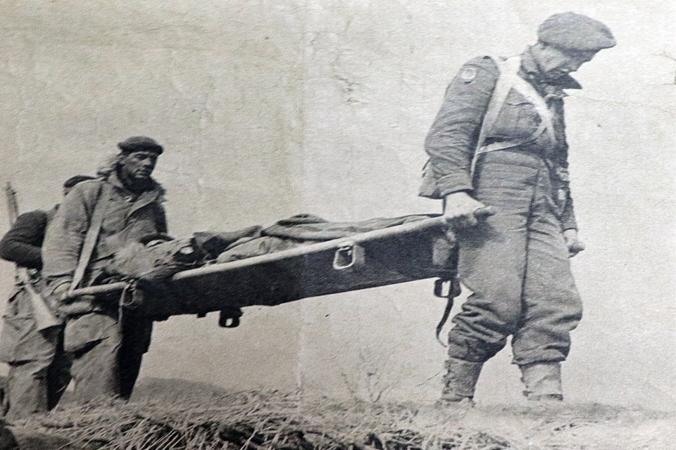 Pte. Russ Sutherland is carried off the Korean battlefield on a stretcher in this newspaper photo following his combat injury in February, 1951. Submitted photo