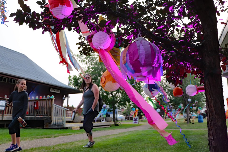 Bowden's Brooke Galay, (left) and mother Kelsey Williams pause to look at the hanging lantern display at the Innisfail Lantern Festival on July 24. Johnnie Bachusky/MVP Staff