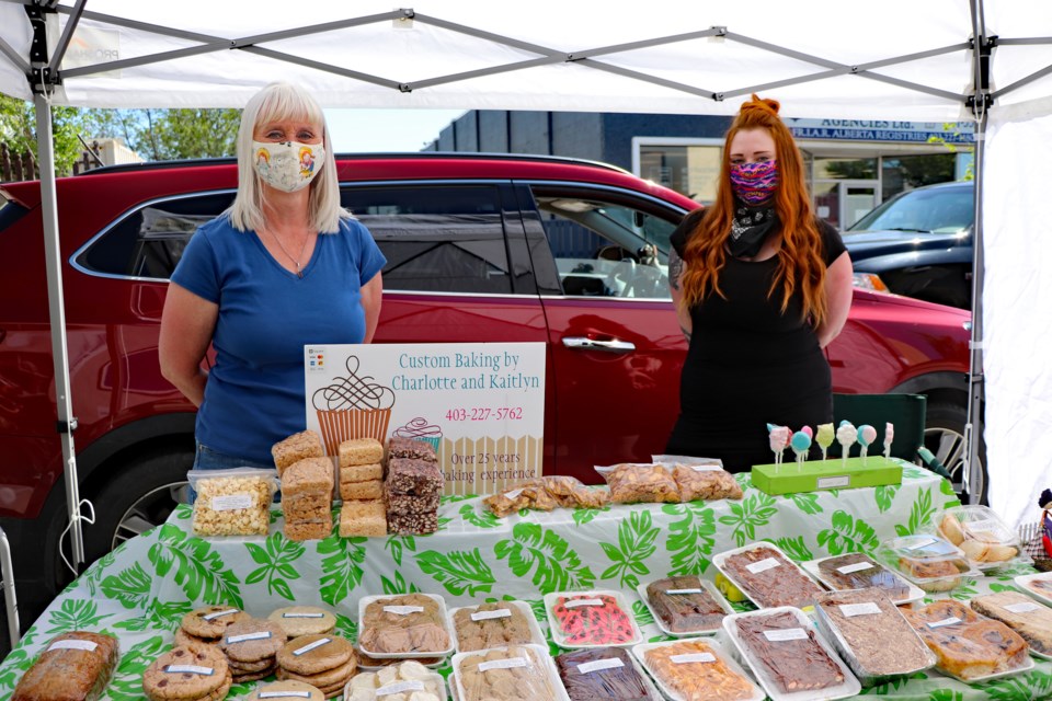Mom Charlotte MacKinnon, left, and daughter Kaitlyn, of Custom Baking, were one of 15 booths set up on June 15 for the first full season of Market On Main in the closed off historical block in downtown Innisfail.
Johnnie Bachusky/MVP Staff