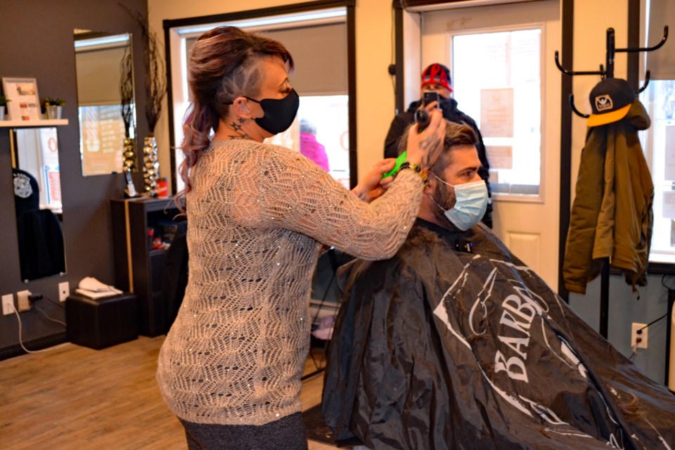 Natalie Klein gives her first haircut after re-opening her hair salon during the morning of Jan. 12. Johnnie Bachusky/MVP Staff