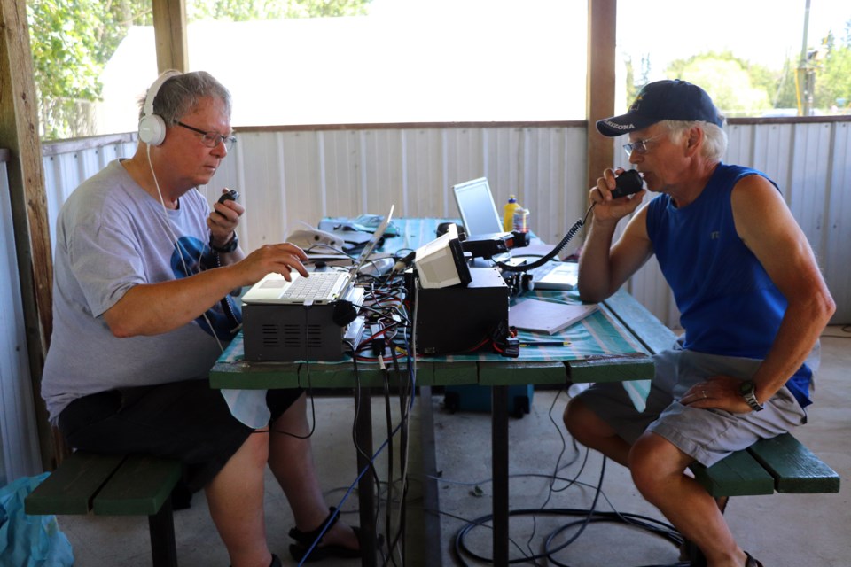 Red Deer's John Allen (left) and Lacombe's Bob King work the calls during the first hour of Field Day on June 26. Johnnie Bachusky/MVP Staff