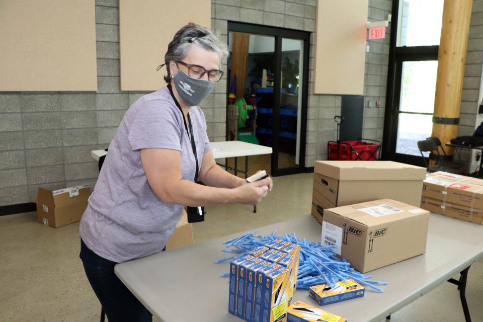 Karen Bradbury, the Town of Innisfail's representative on YPAC, and its community and social development coordinator, sorts through items on June 11 that went into each activity and information bag for 760 Innisfail students. Johnnie Bachusky/MVP Staff