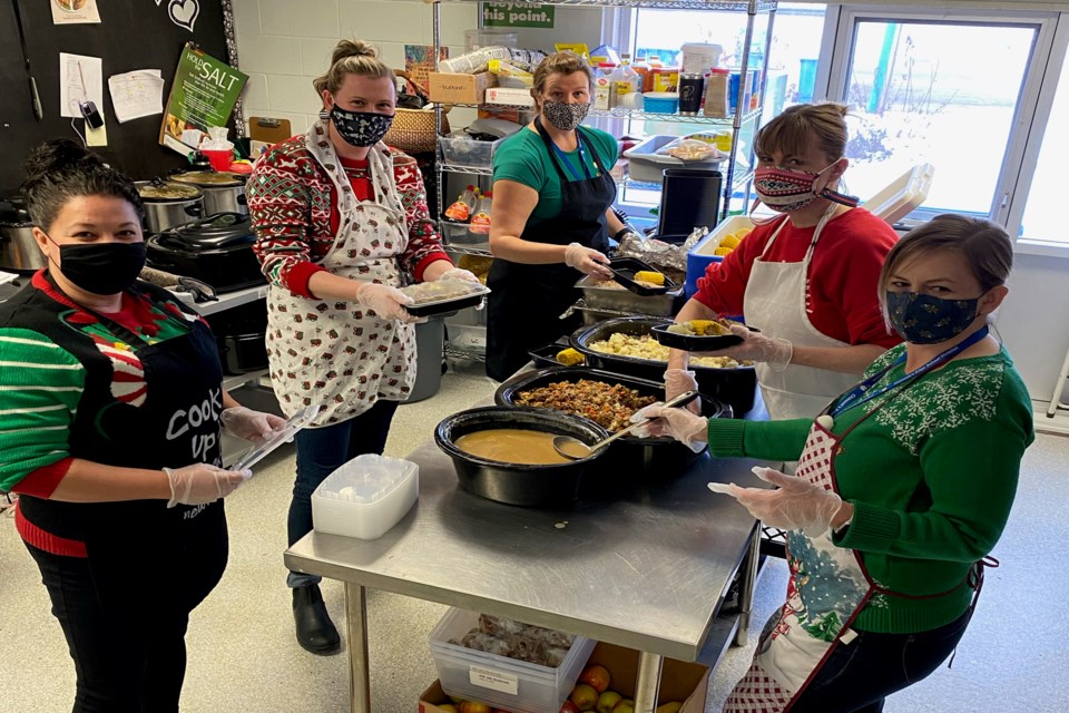 All hands on deck as the staff portion and prepare the turkey dinners for each student and staff member. From left to right is Melissa Rose, administrative assistant; Lisa Baird, school principal; Caroline Tindall, nutrition coordinator; Suzy Argent, educational assistant and Lisa Keeler, educational assistant. Photo by Grade 4 teacher Kristine Horrocks 