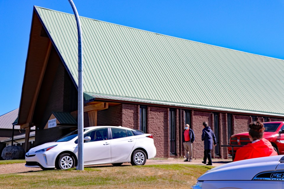 Citizens, including congregation members, pause outside the Innisfail United Church on June 6 for the ringing of bells for the 215 Indigenous children whose undocumented graves were recently discovered in Kamloops, B.C. Johnnie Bachusky/MVP Staff