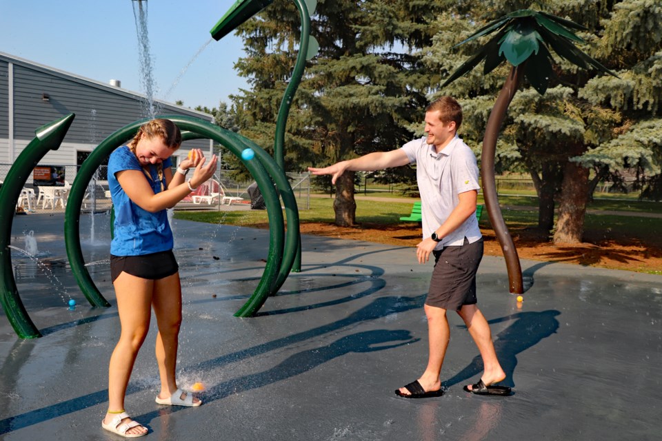 Josh Gette, right, throws a reusable water ball at Kelly Eggink last week during a trial run for the Innisfail Water Warz! on July 30. Both are senior lifeguards for the Innisfail Aquatic Centre that is hosting the first ever event. Johnnie Bachusky/MVP Staff